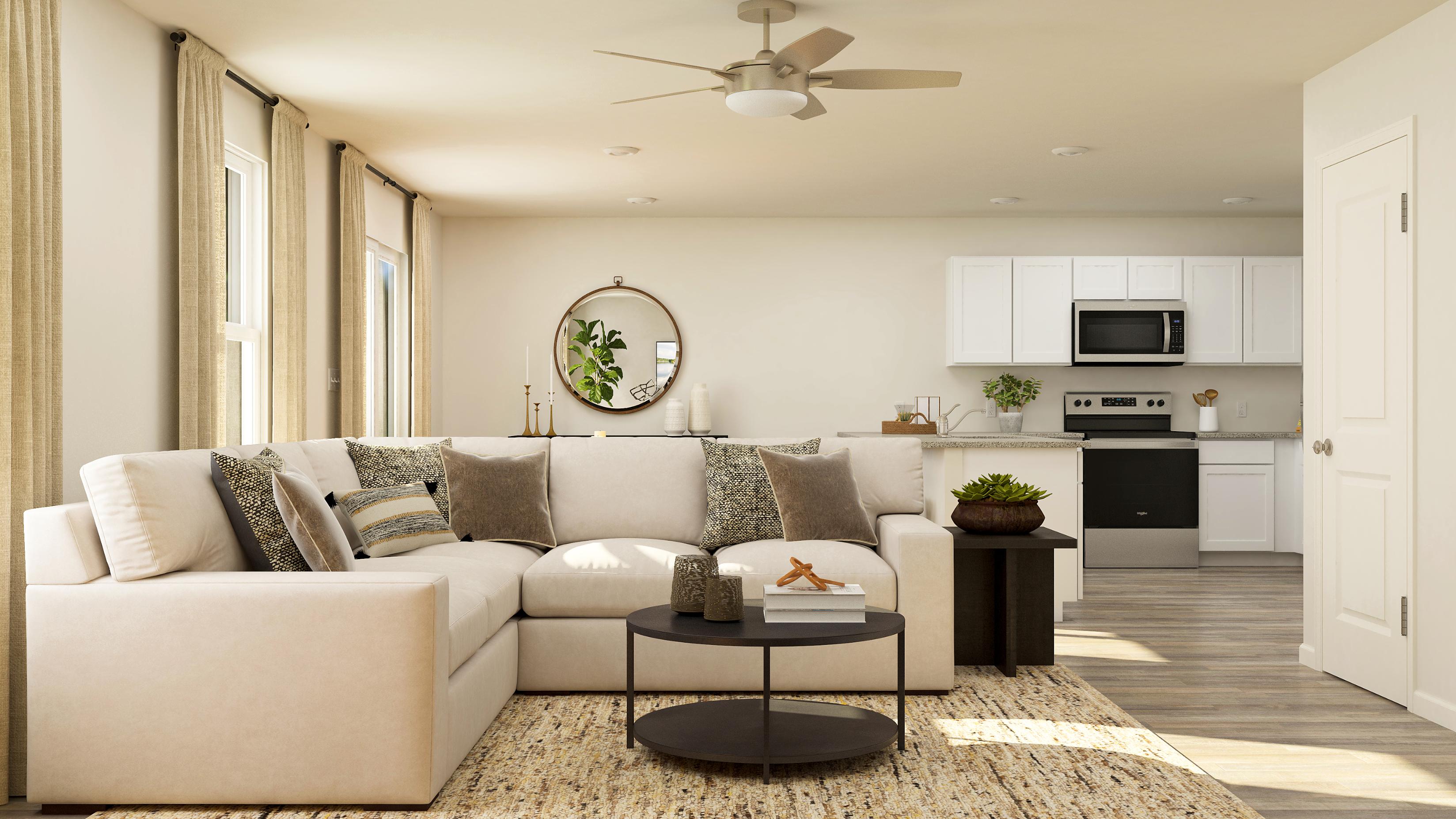 A living room with a white couch and a table.