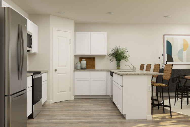 A kitchen with white cabinets.