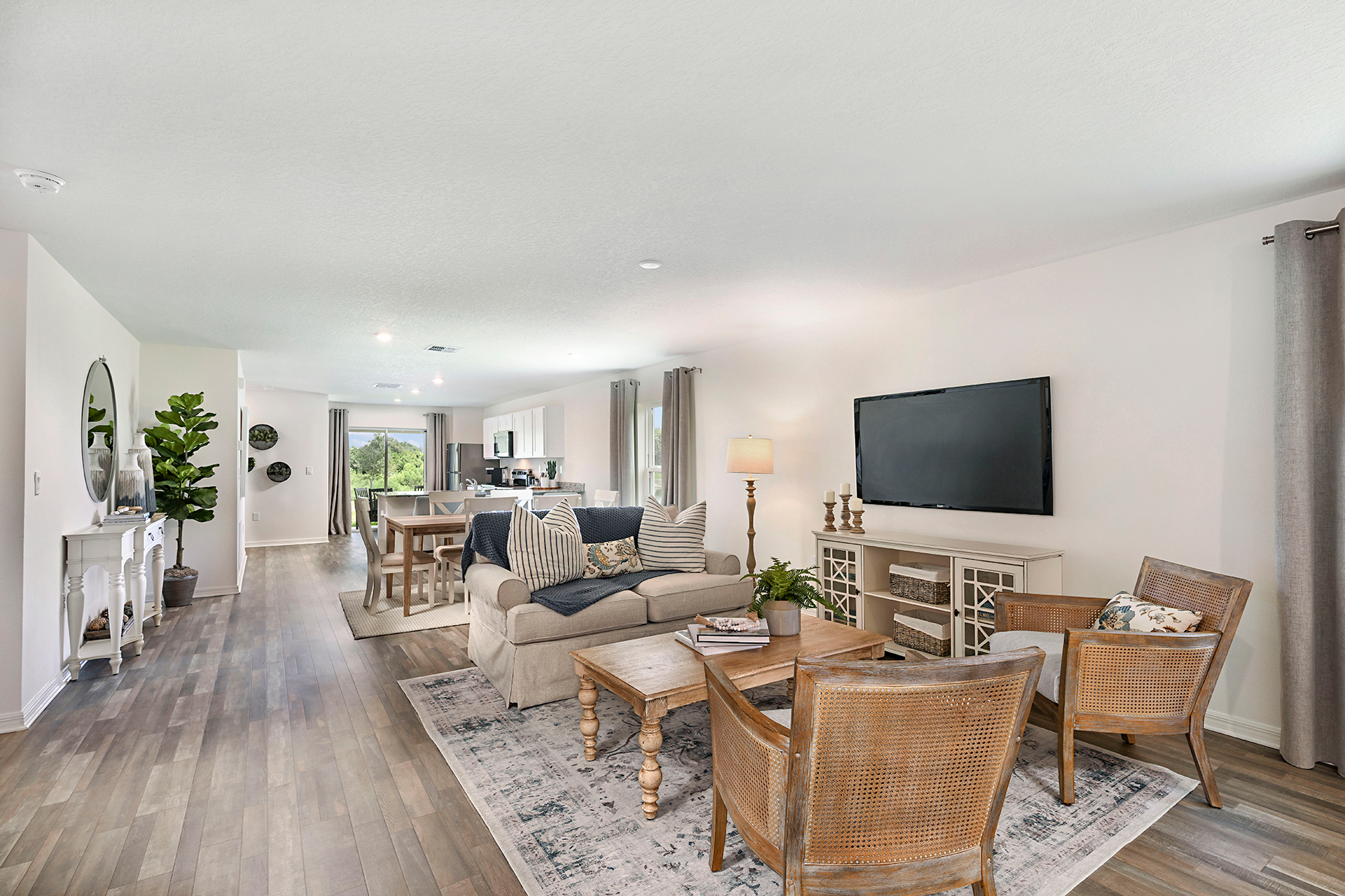 A living room with a tv and chairs.
