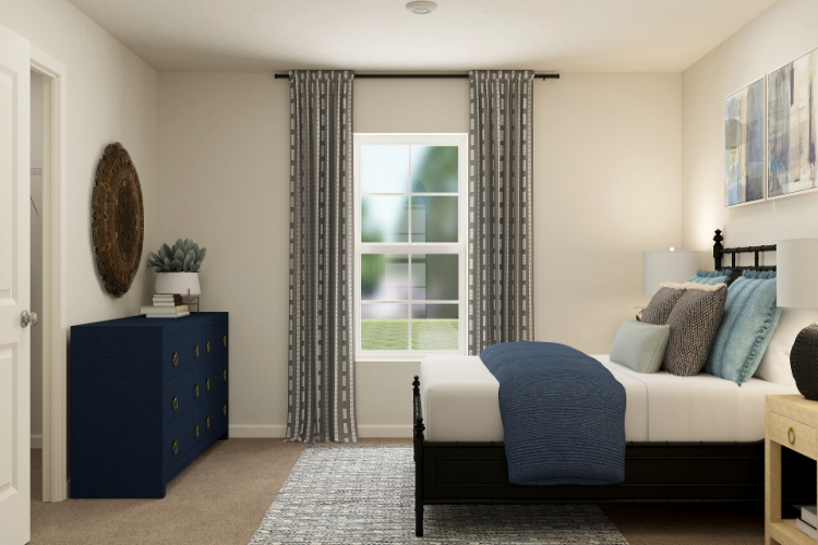 A bedroom with a bed and a couch.