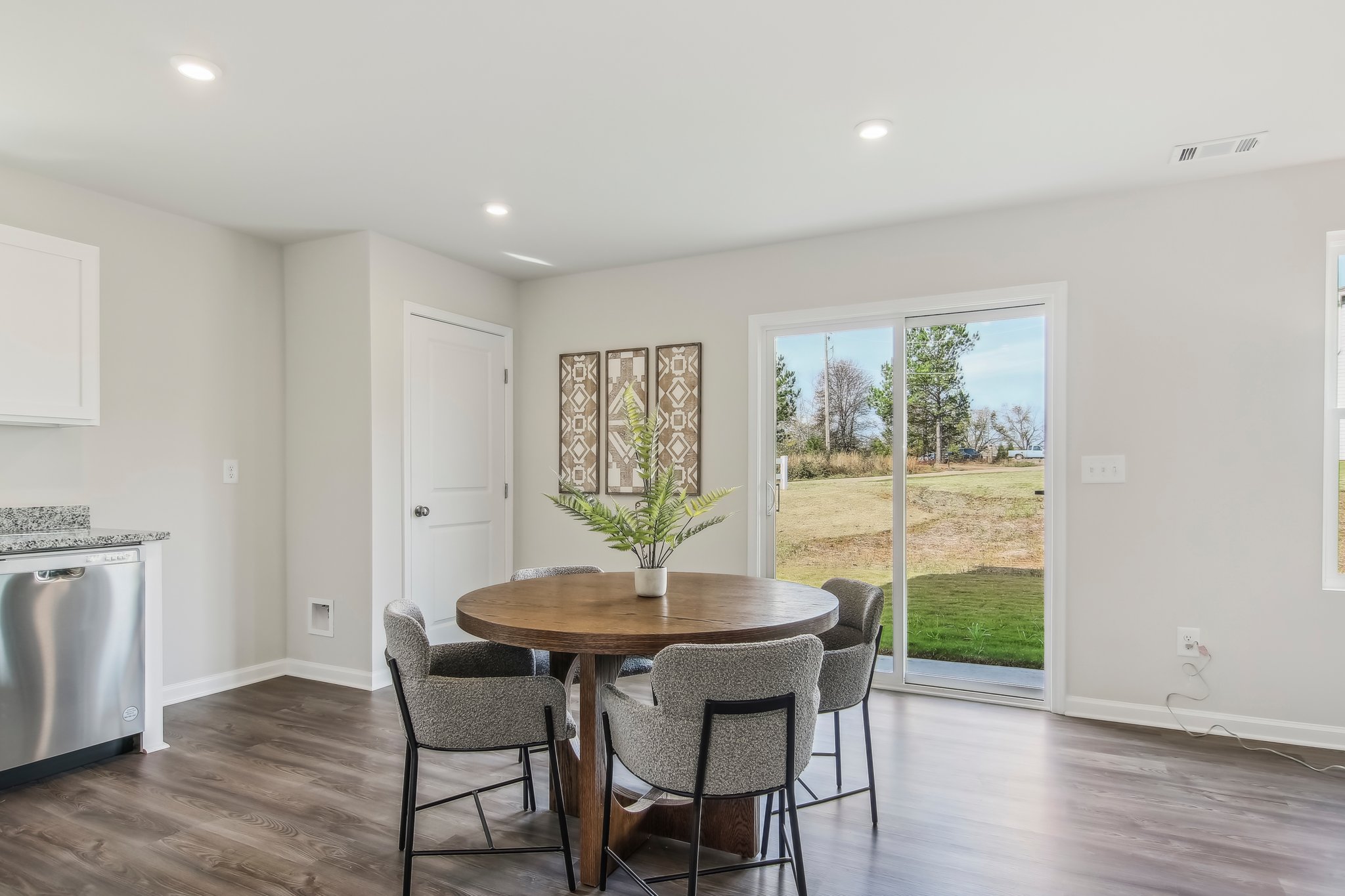 A dining room with a large glass door.