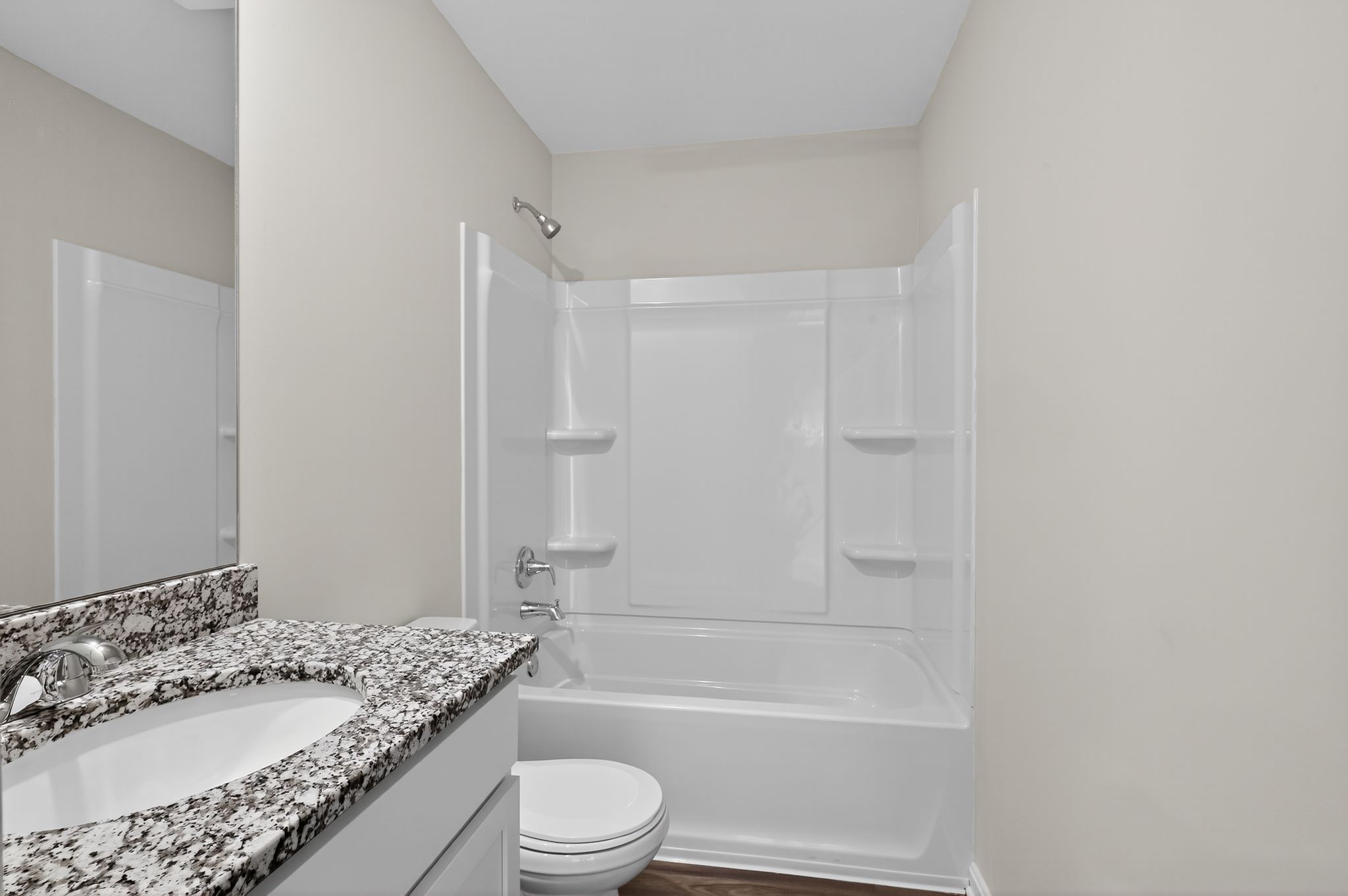 A bathroom with a marble countertop.