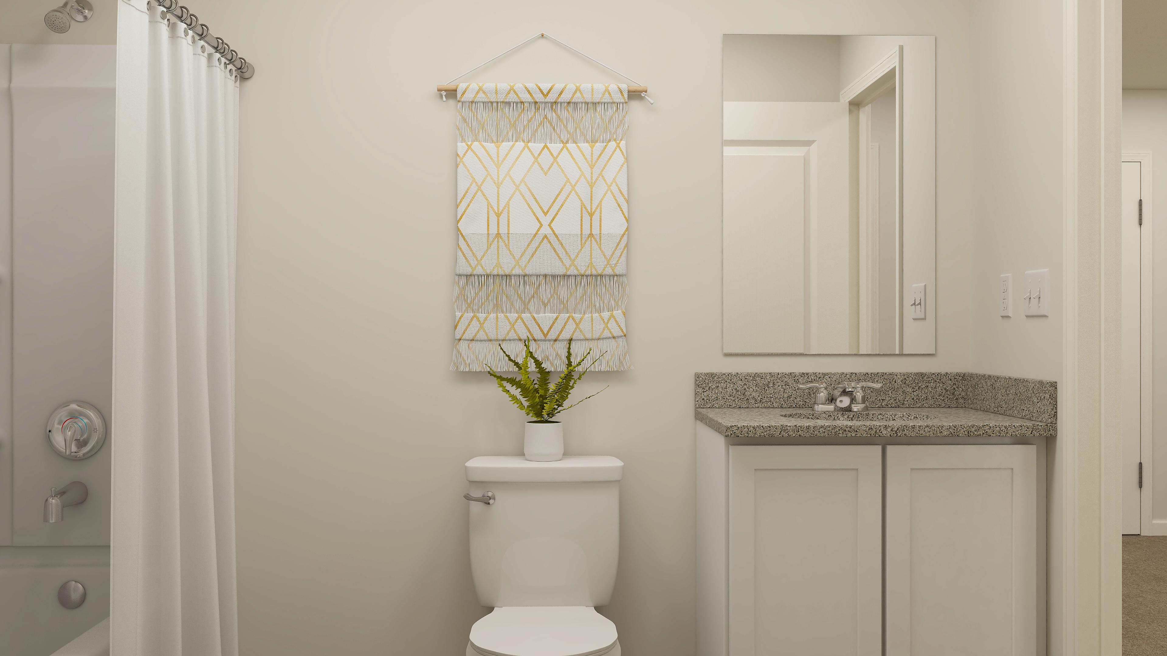 A bathroom with a plant on the toilet.
