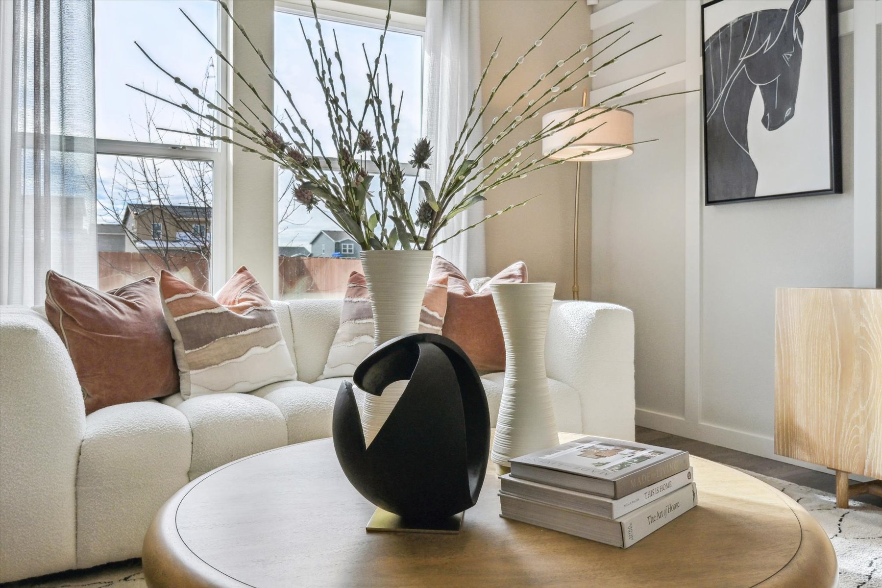 A living room with a white couch and a coffee table.