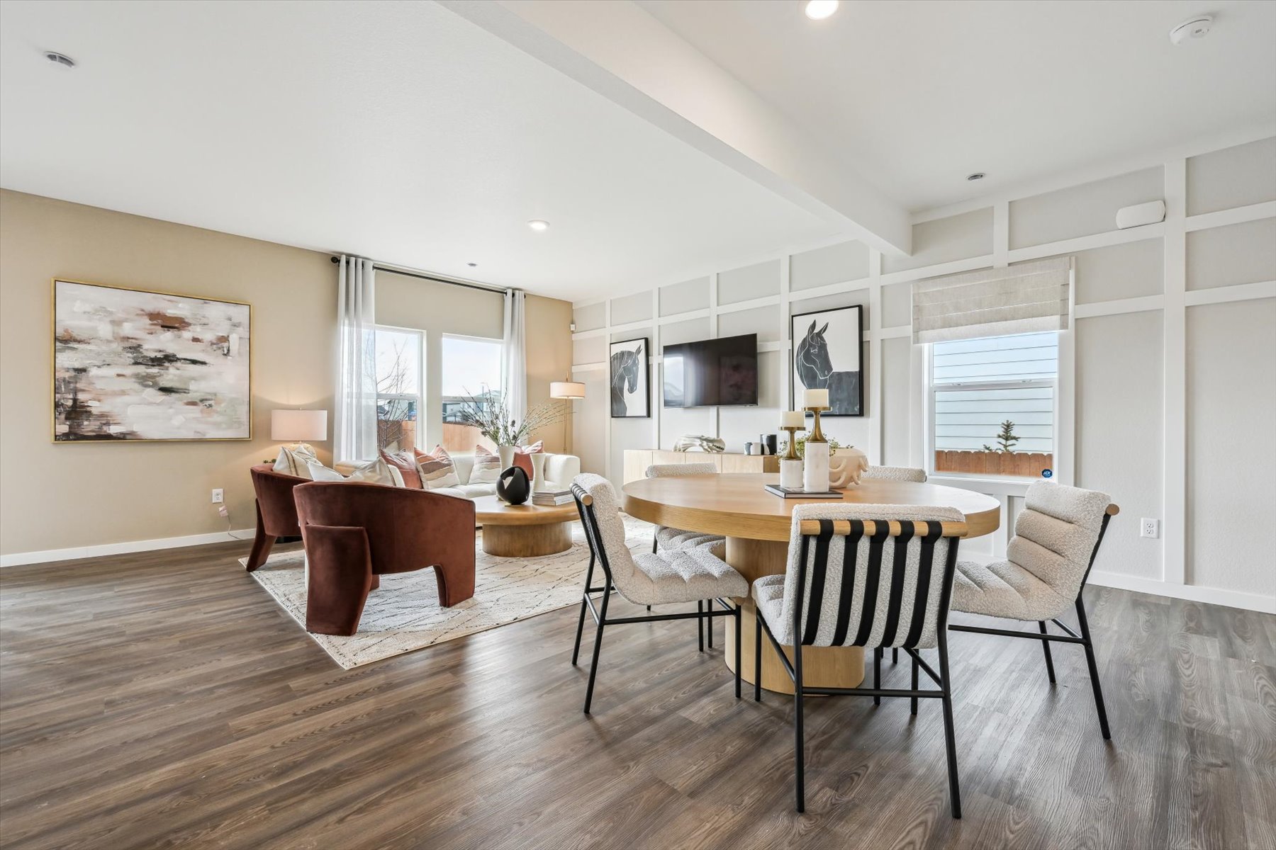 A large dining room with a wood floor.
